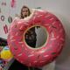 Photo of Lauren eating a giant inflatable pink donut